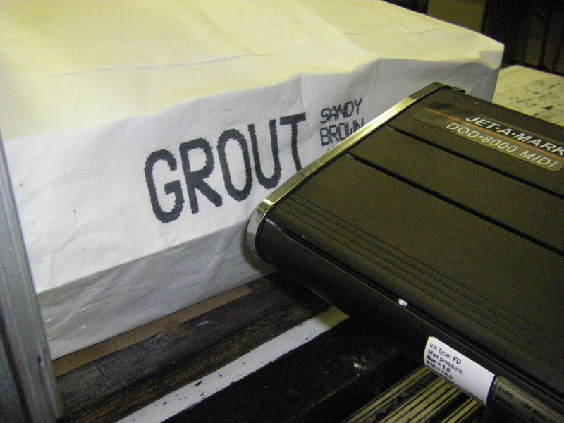drop-on-demand inkjet marking system printing mark and code on grout or concrete paper bag