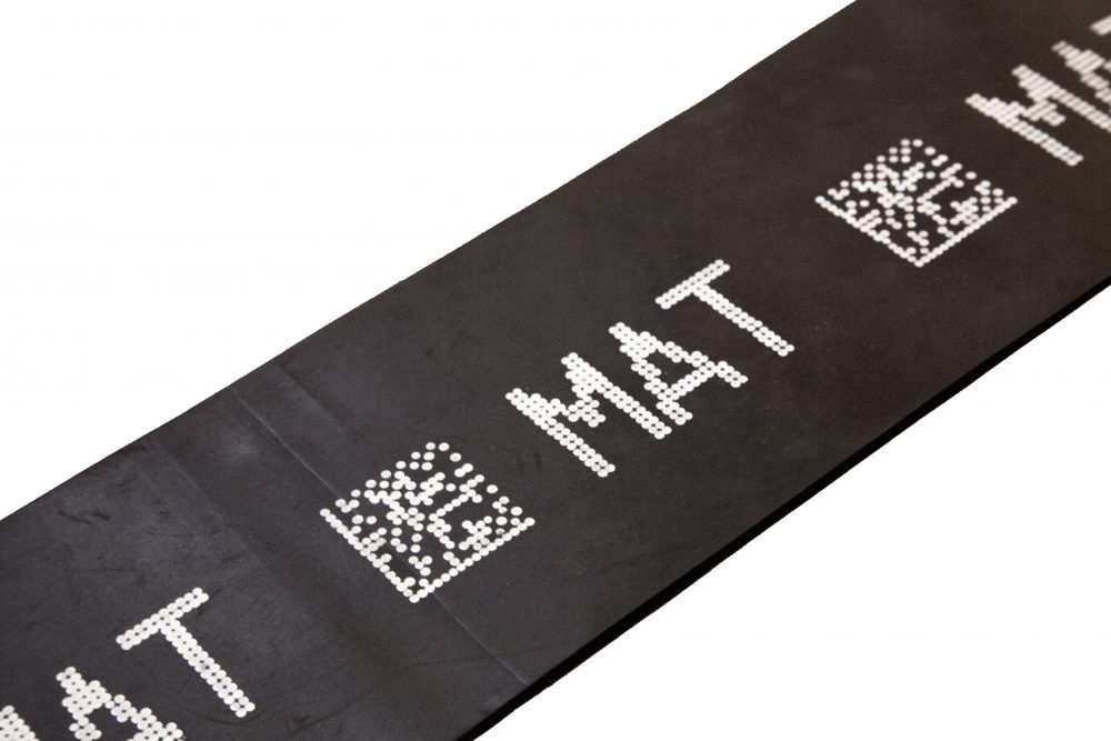 Rubber mat with human readable text and 2D code made with V-Series drop-on-demand marking system 
