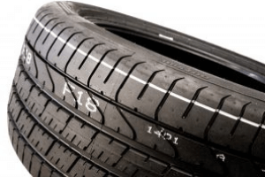 Rubber tire with code printed on tread, mark made with Matthews Marking System